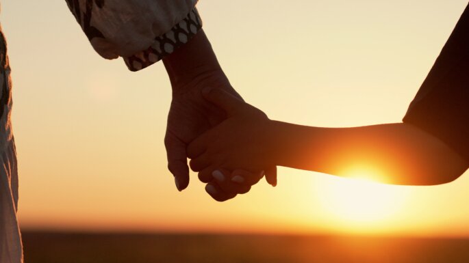 Mom,And,Child,Holding,Hands,Together,On,Sunset,Background.,Silhouette